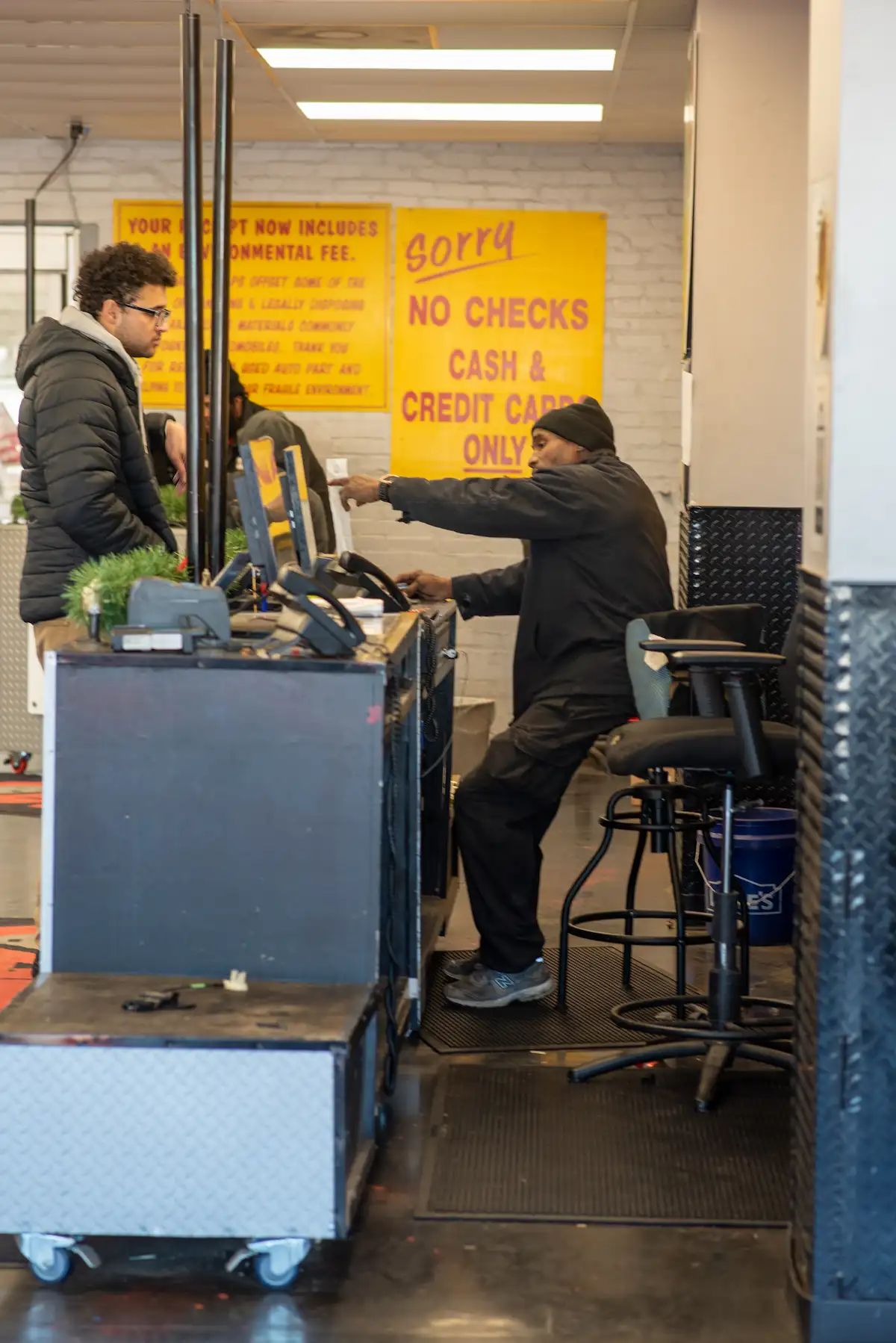 Customer being helped by an employee at a self-serve salvage yard